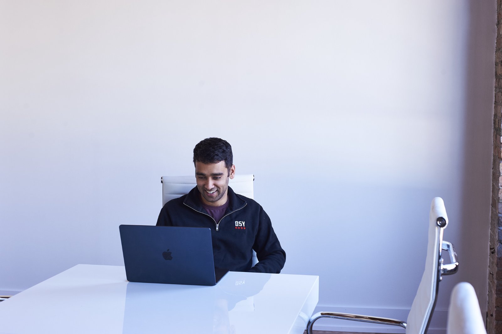 A founder working on a laptop in the studio