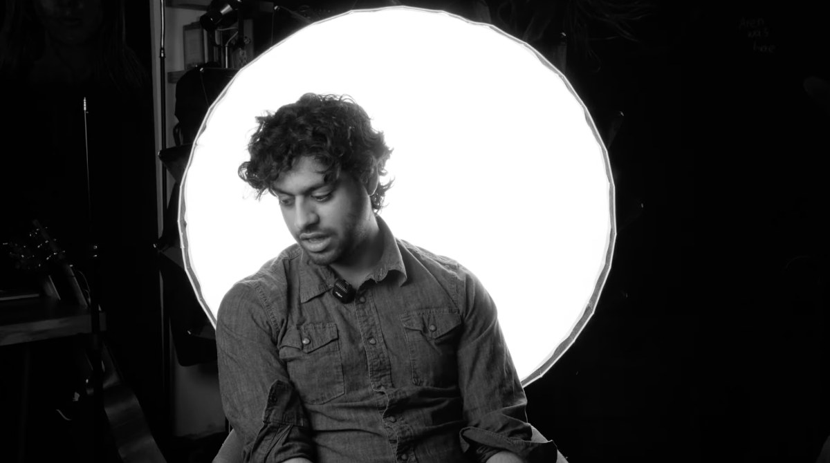 Black-and-white portrait of an operator in front of a ring light