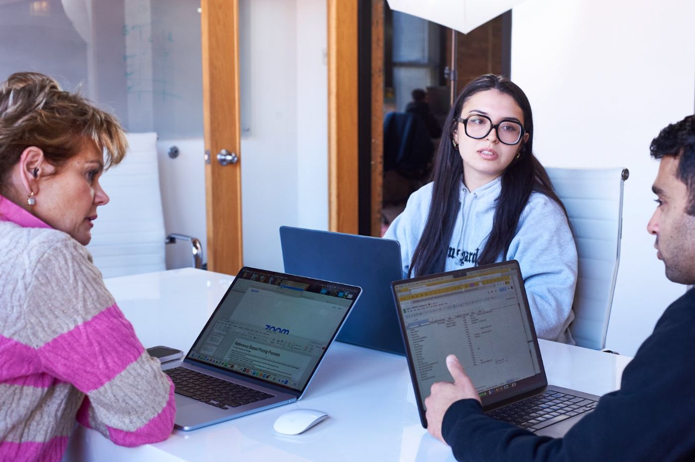 Three founders in a working session around their laptops
